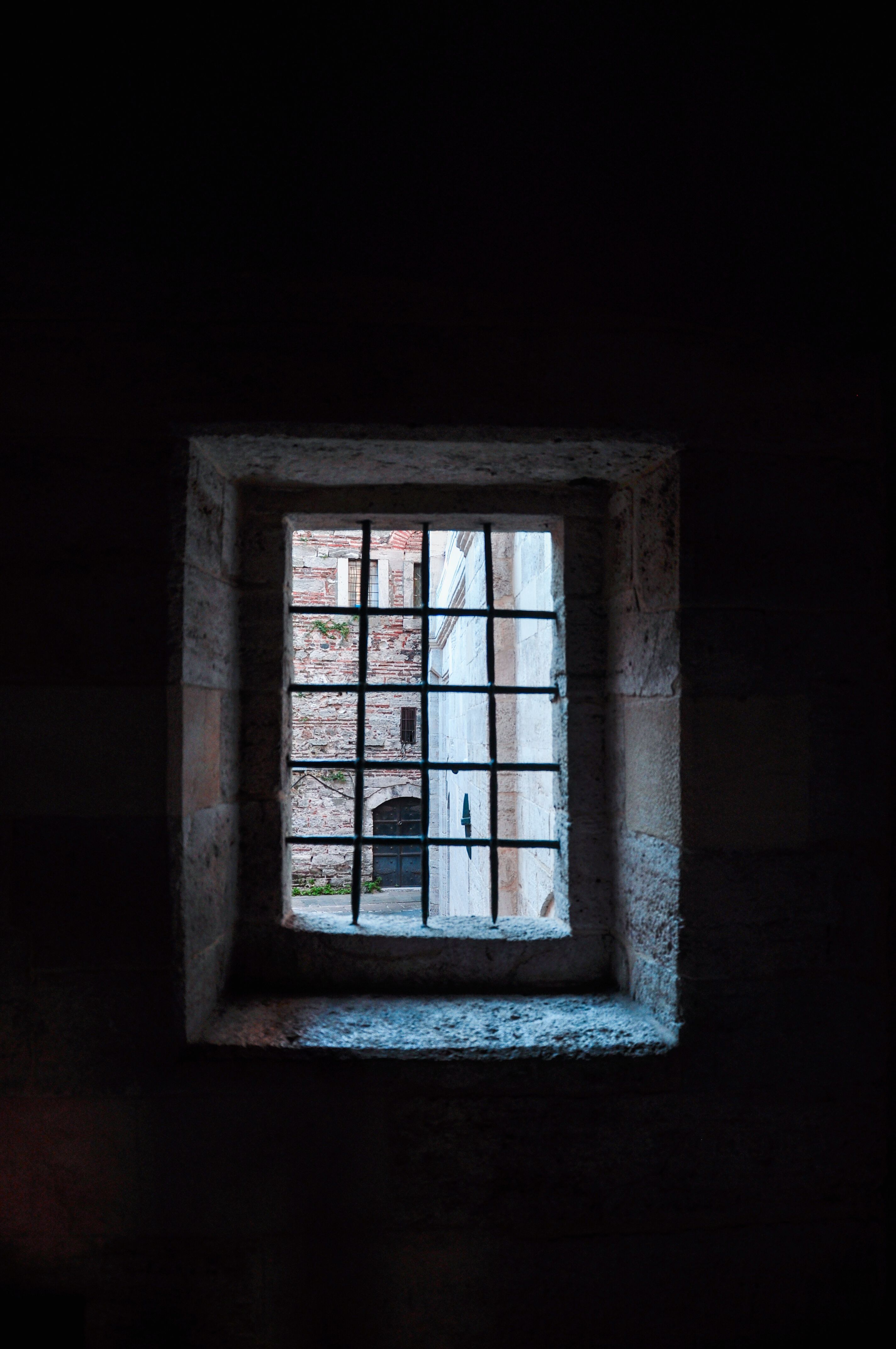 Historic Stone Window with Iron Bars · Free Stock Photo