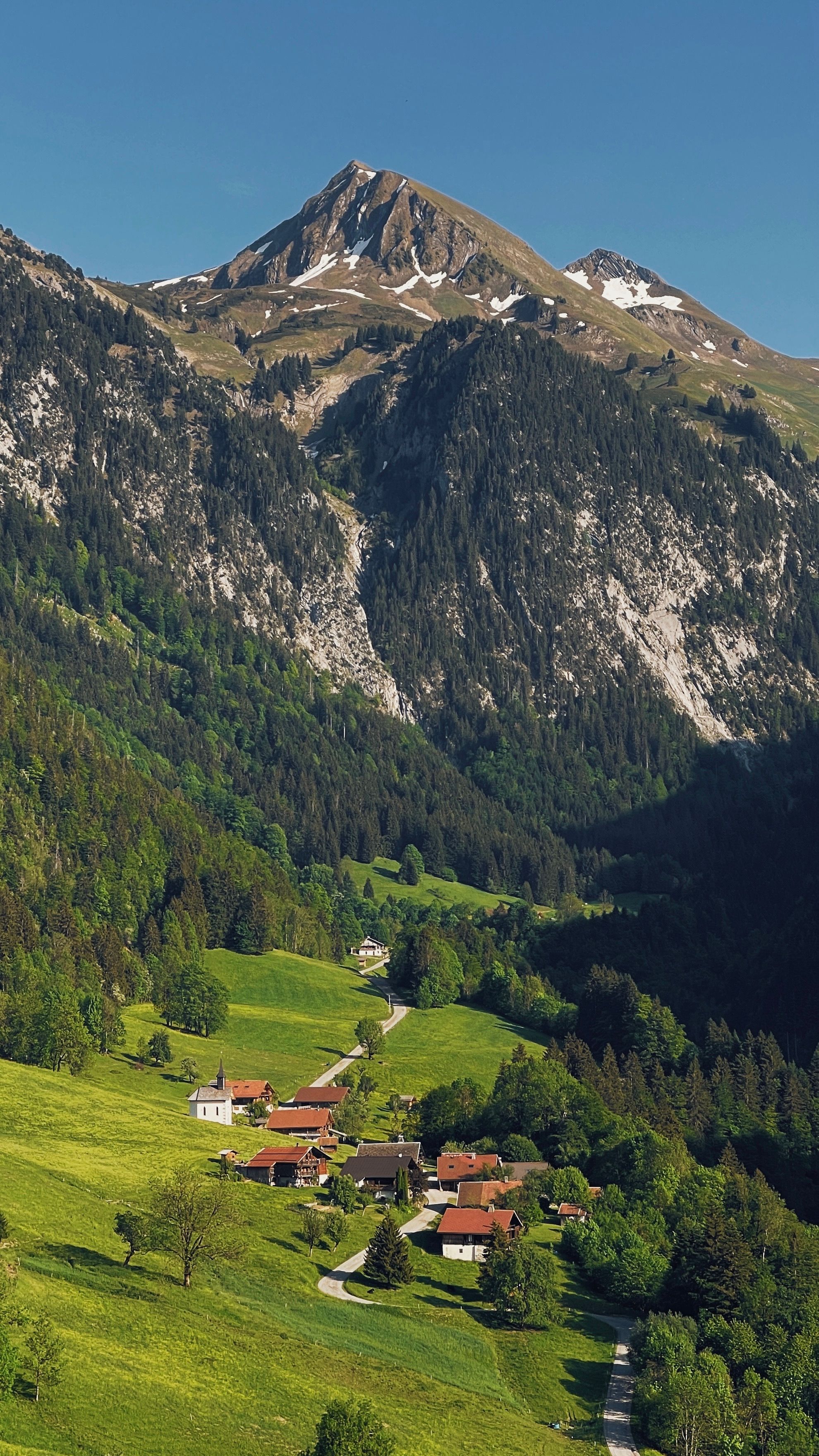 Scenic Alpine Village in Lush Green Valley · Free Stock Photo
