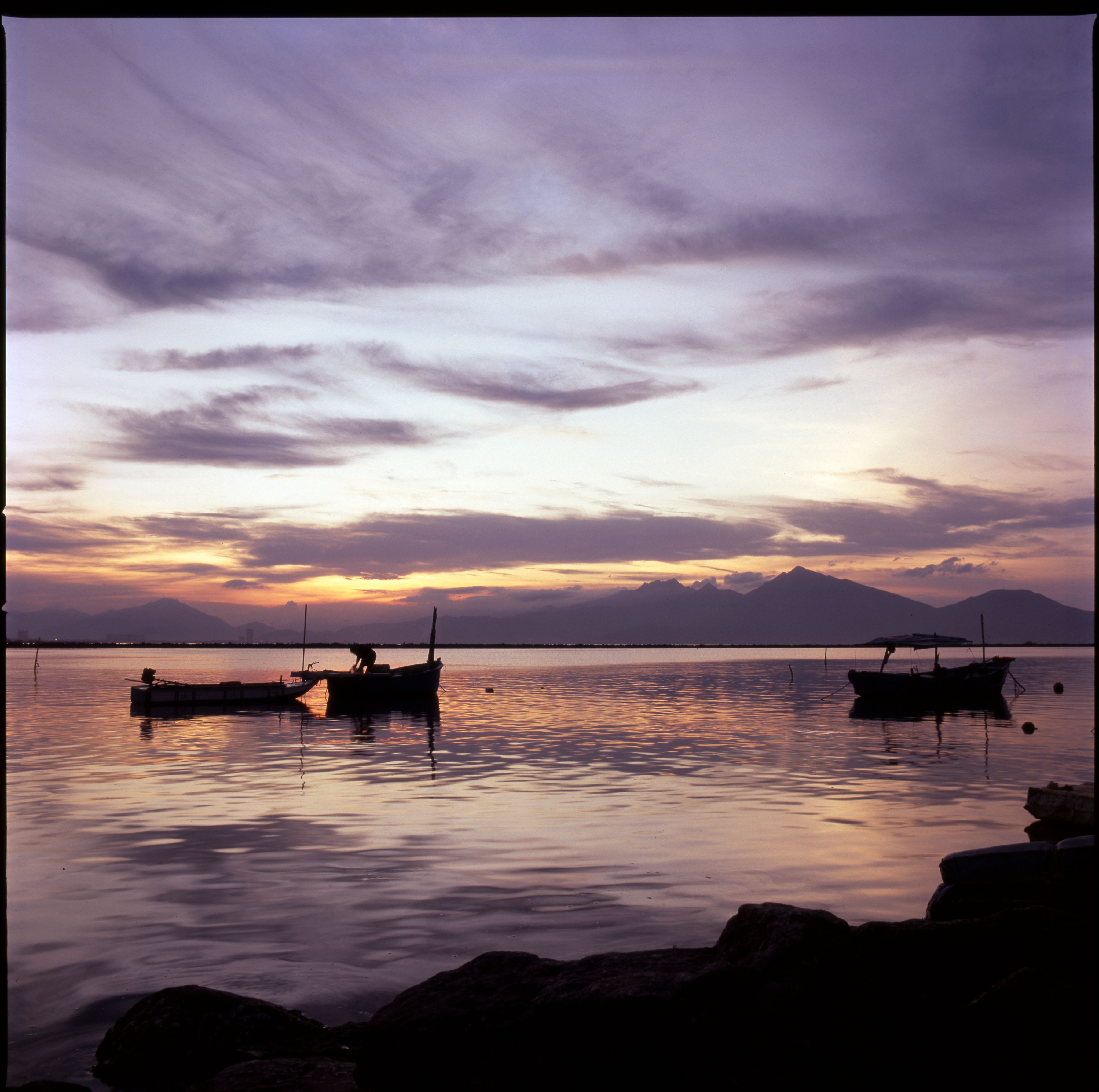 Tranquil Sunset with Boats Silhouetted on Calm Water · Free Stock Photo