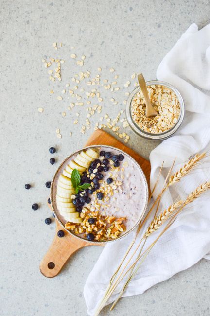 Delicious oatmeal bowl topped with banana, blueberries, and nuts, perfect for a healthy start.