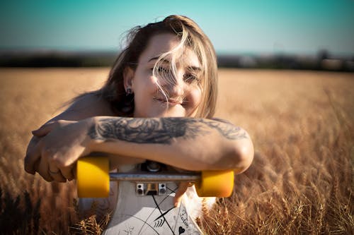 Free Photo Of Woman Holding Her Skateboard Stock Photo