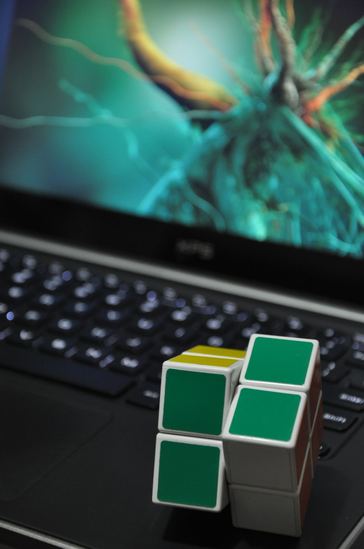 colorful 3x3 cube resting on a laptop keyboard