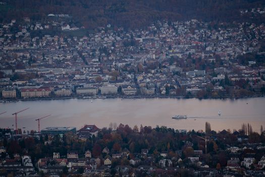 A scenic aerial view of Lake Zurich with the waterfront and surrounding cityscape during fall.