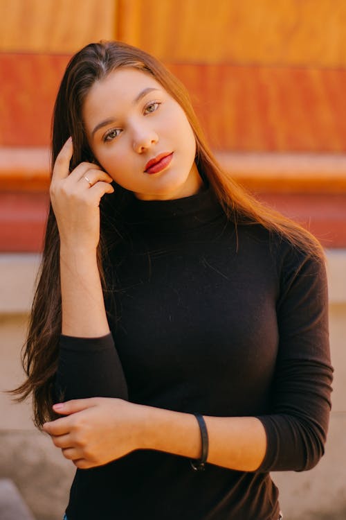 Selective Focus Photo of  Woman in Black Long-sleeved Top Posing