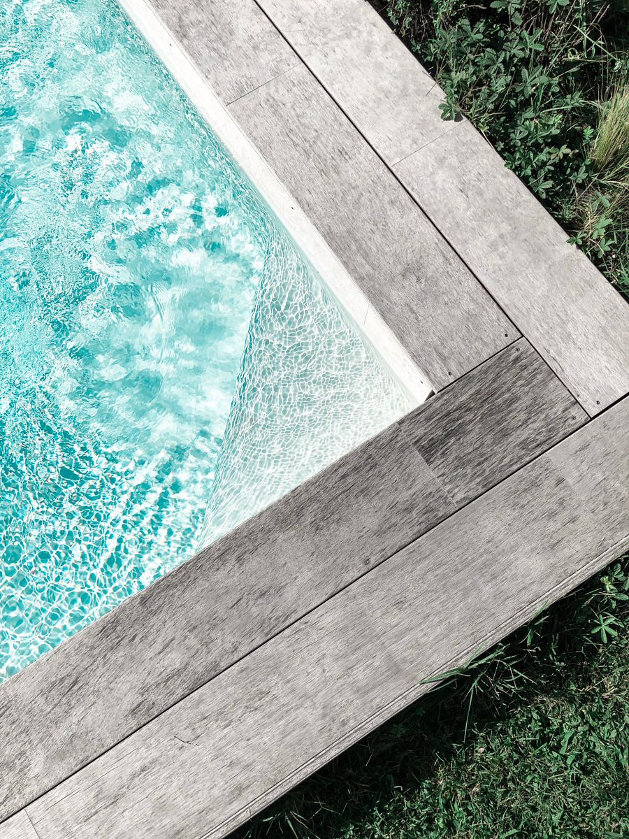 Aerial view of a finished pool edge and deck