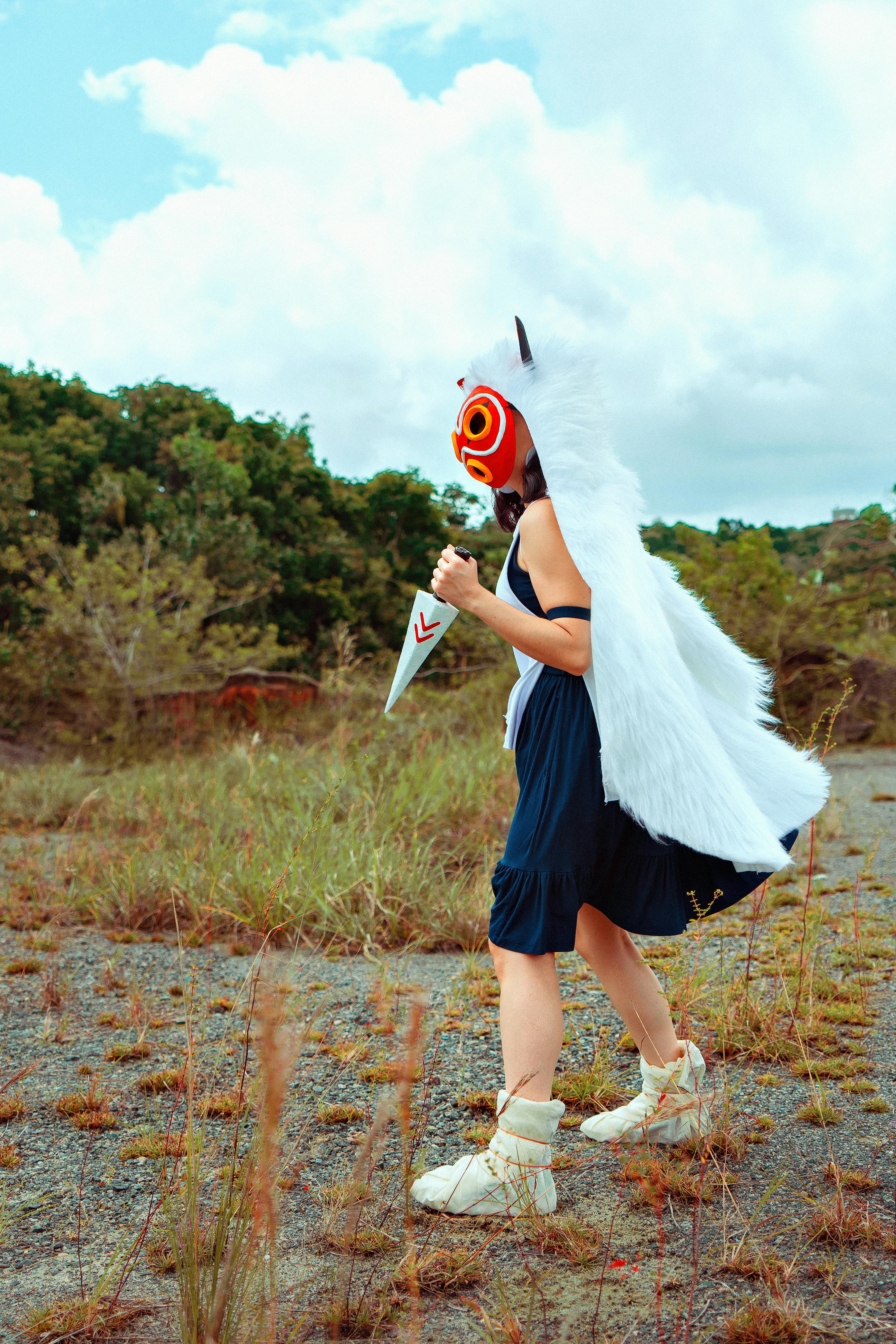 person in cosplay mask walking outdoors