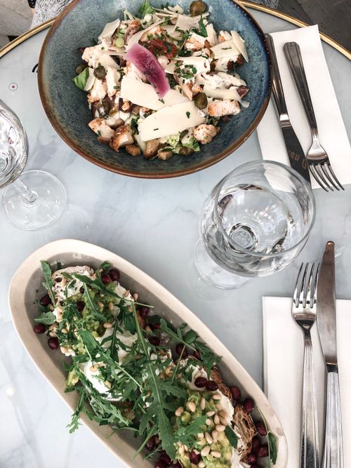 Free Overhead view of fresh gourmet salad dishes on elegant dining table setting. Stock Photo