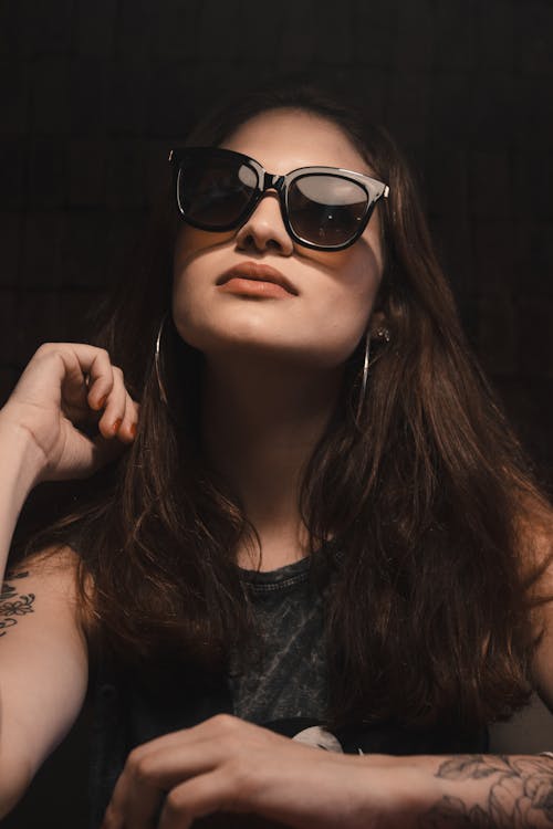 Portrait of Woman with Long Hair  Wearing Sunglasses