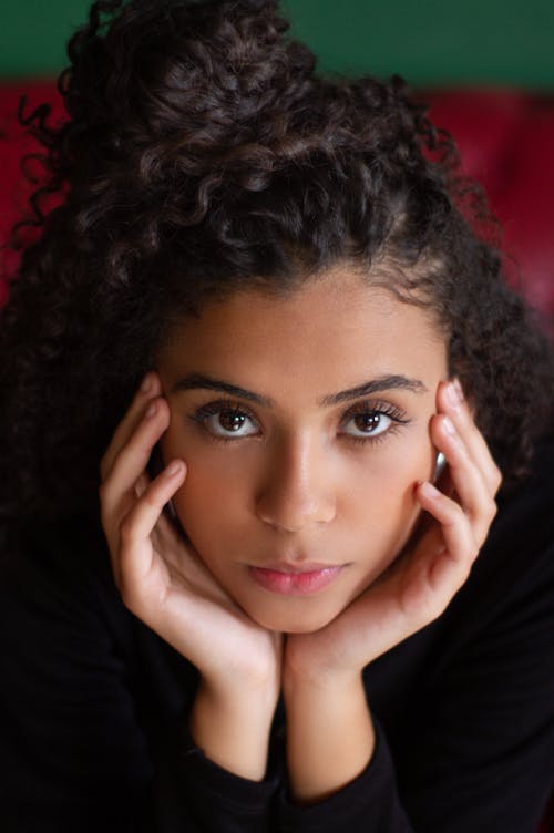 Close Up Photo of a Woman Resting Her Face on Her Hands