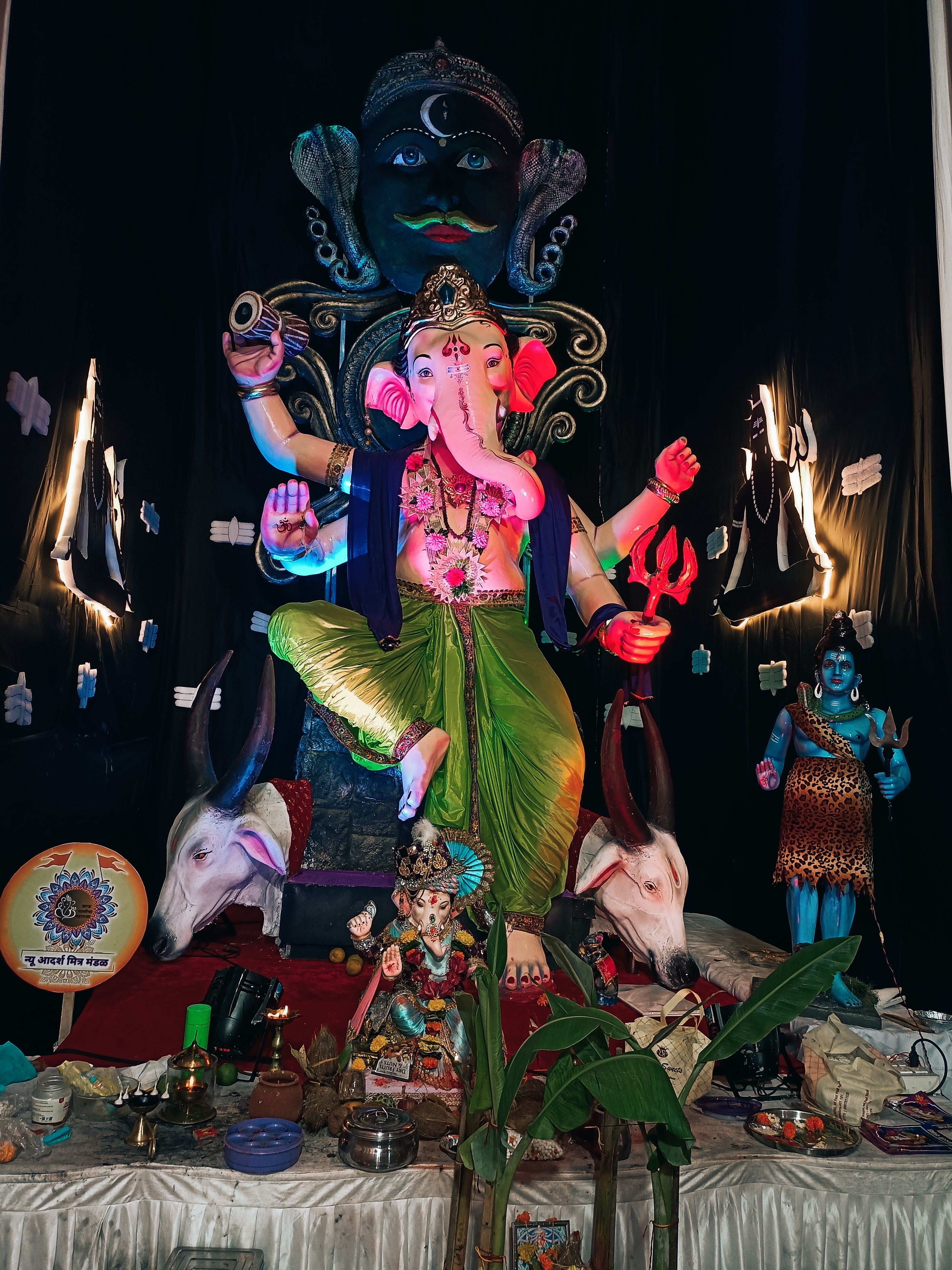 Elaborate Ganesh Chaturthi celebration featuring a decorated Ganesh idol with festive offerings.