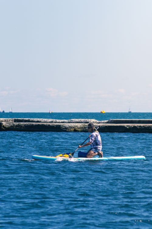 Free Solo paddle boarder enjoying a sunny day on Lake Ontario in Toronto, Canada. Stock Photo