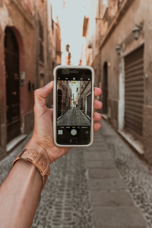 Photo of Person Holding Mobile Phone