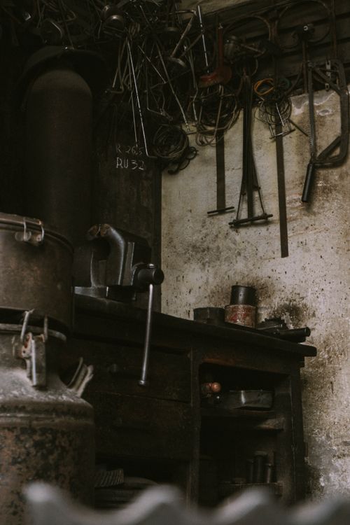 Free A vintage workshop corner with hanging tools and rustic ambiance. Stock Photo