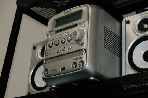 Free A classic silver stereo system with speakers on a shelf, showcasing retro design. Stock Photo
