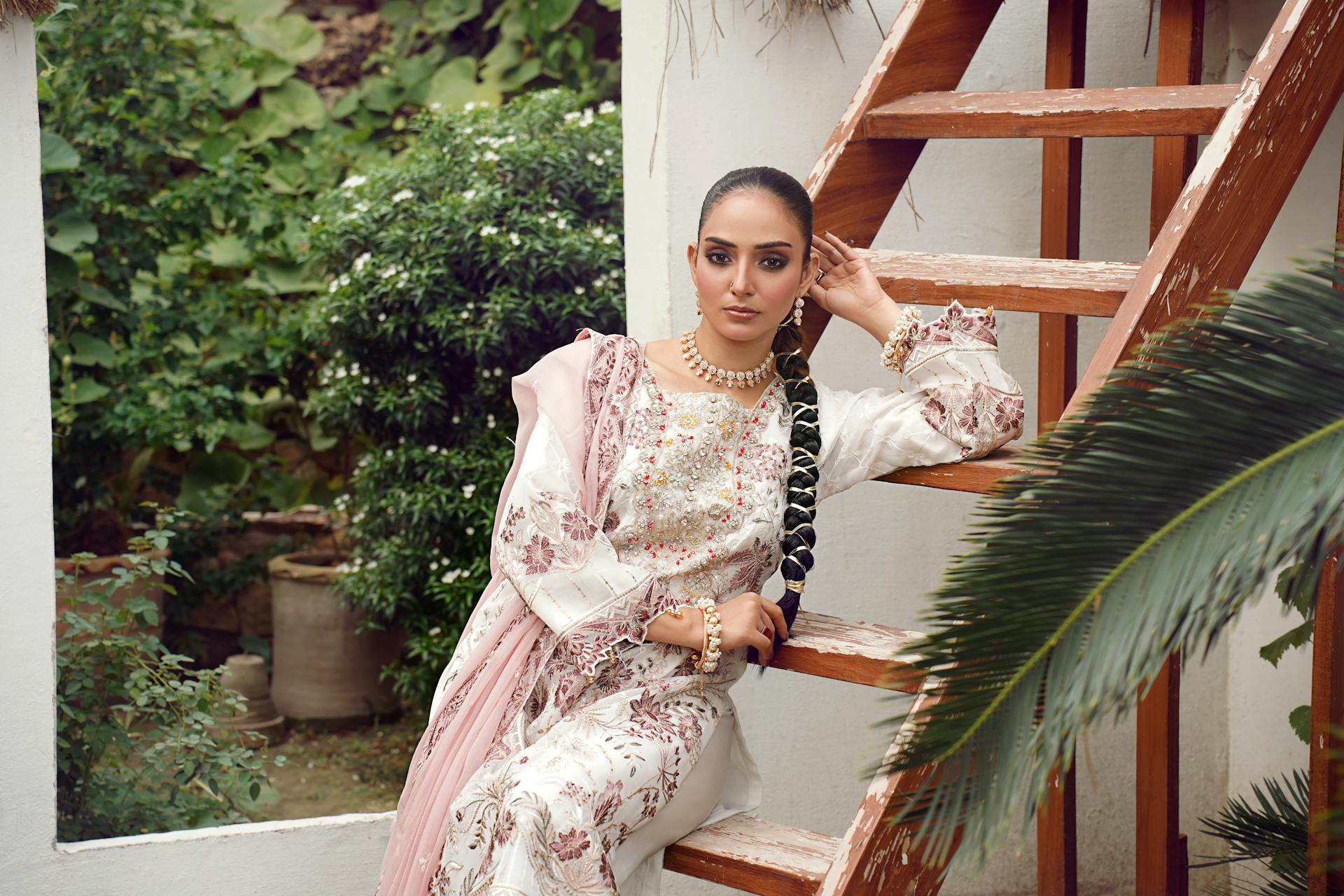 Elegant Woman in Traditional Eastern Dress in Lush Setting