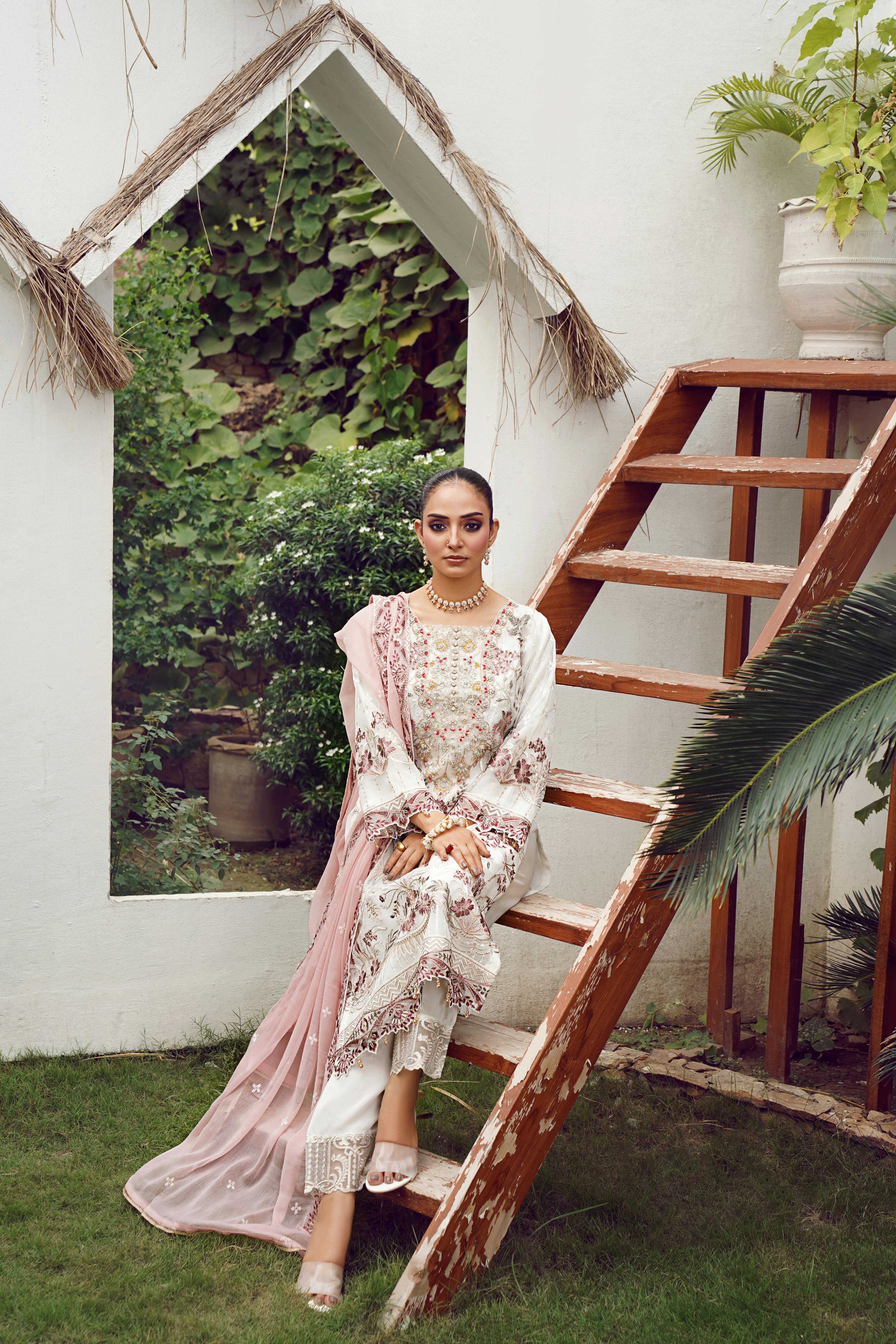 Fashion model in traditional dress posing in Lahore garden setting