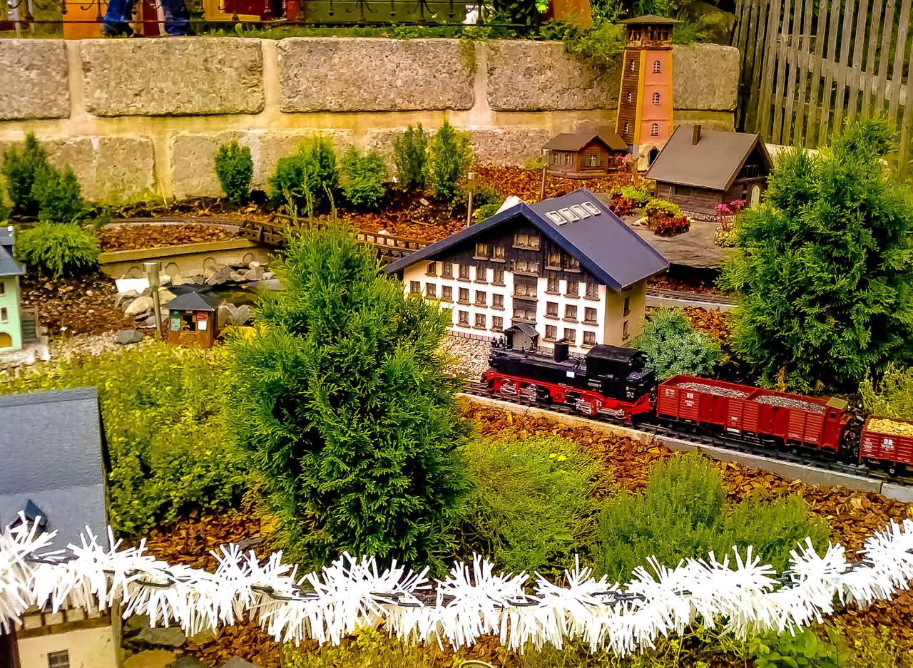 charming miniature train in a detailed garden setting with model build