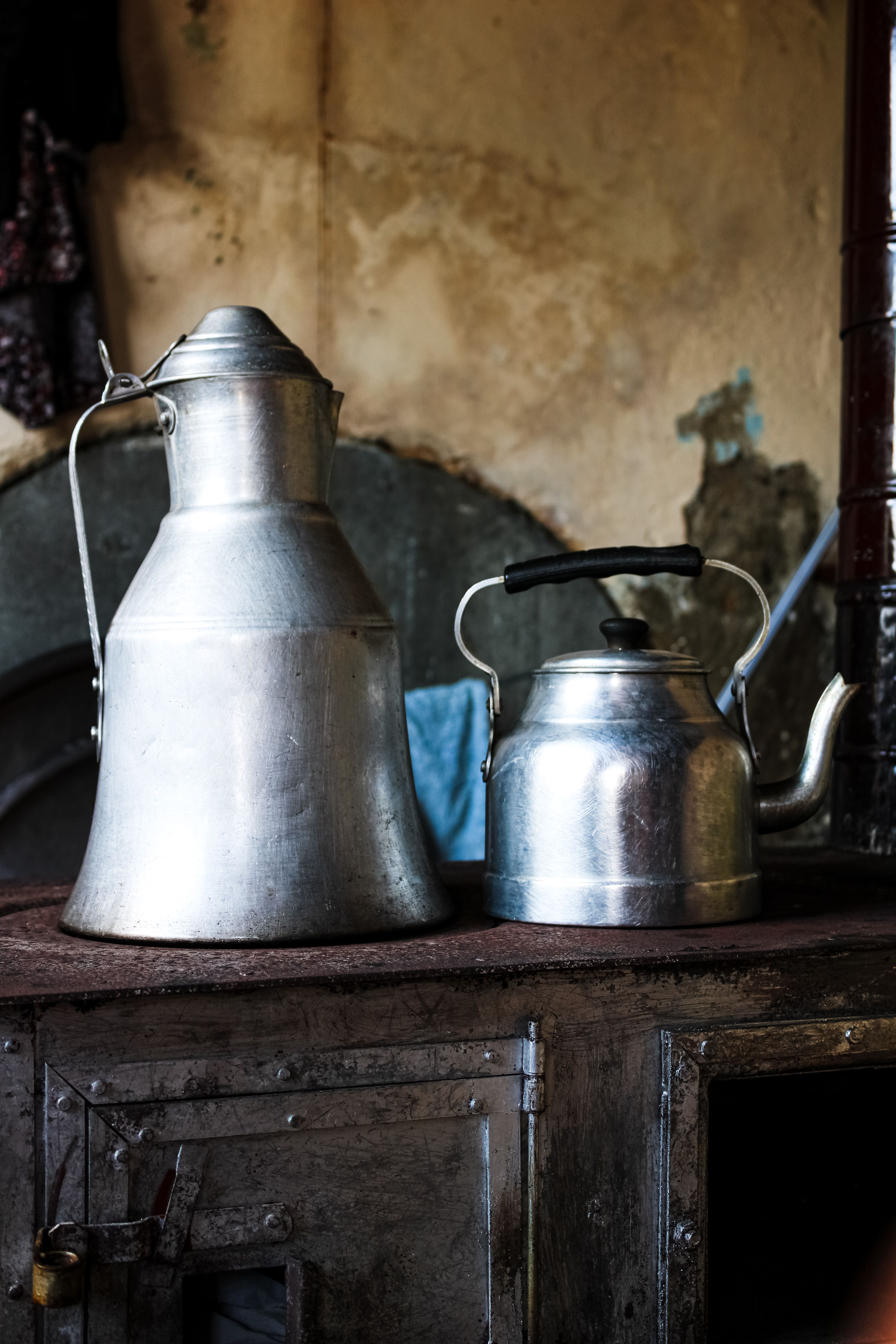 Vintage metal teapots on stove evoke rustic charm in Trabzon, Türkiye.