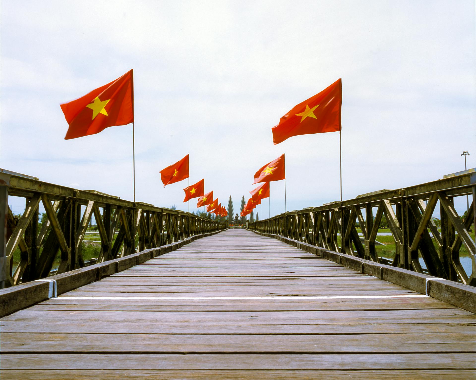 Wooden Bridge with Vietnamese Flags Displayed