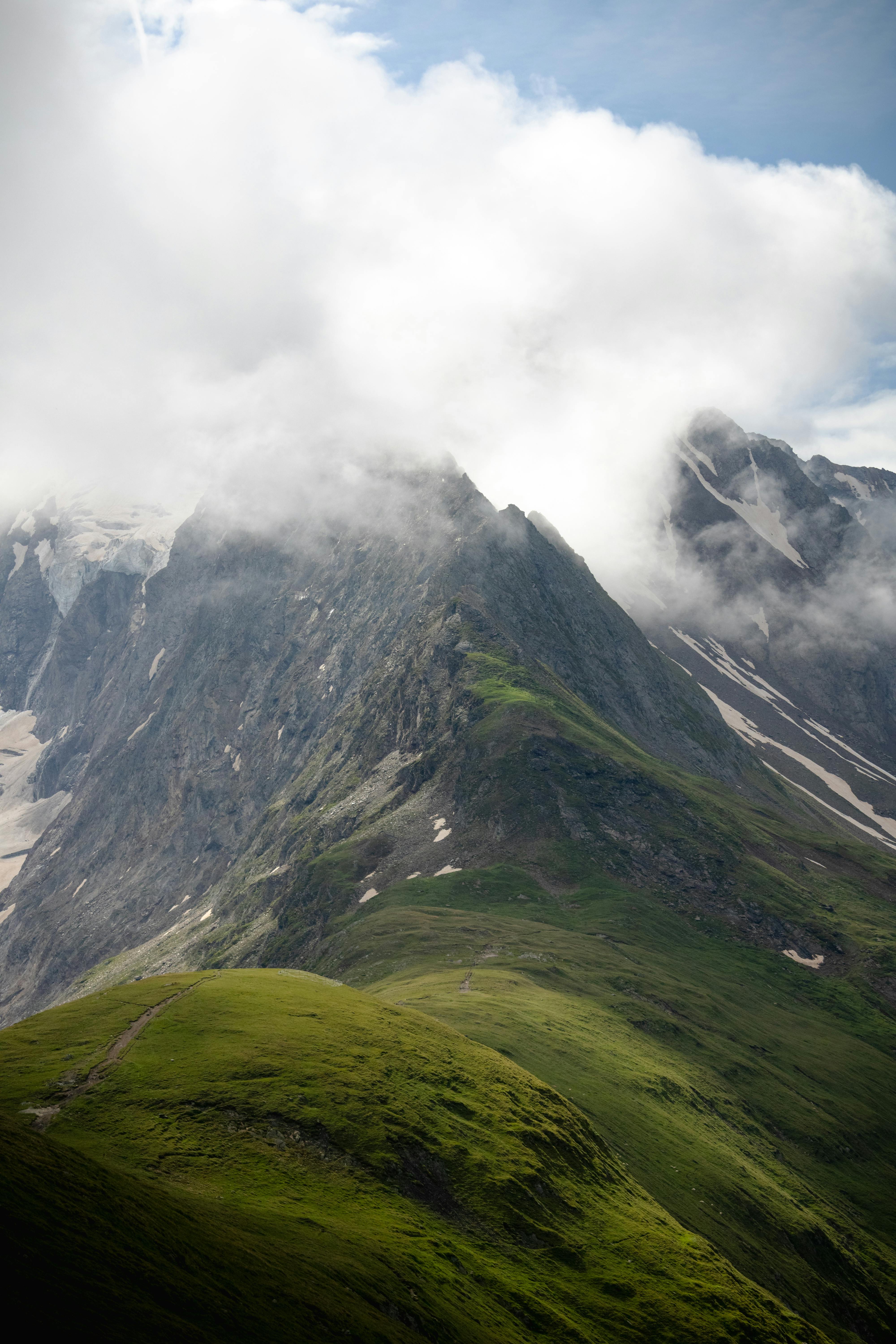 Explore the stunning alpine scenery in Obergurgl, Tirol, with lush green mountains and cloudy skies.