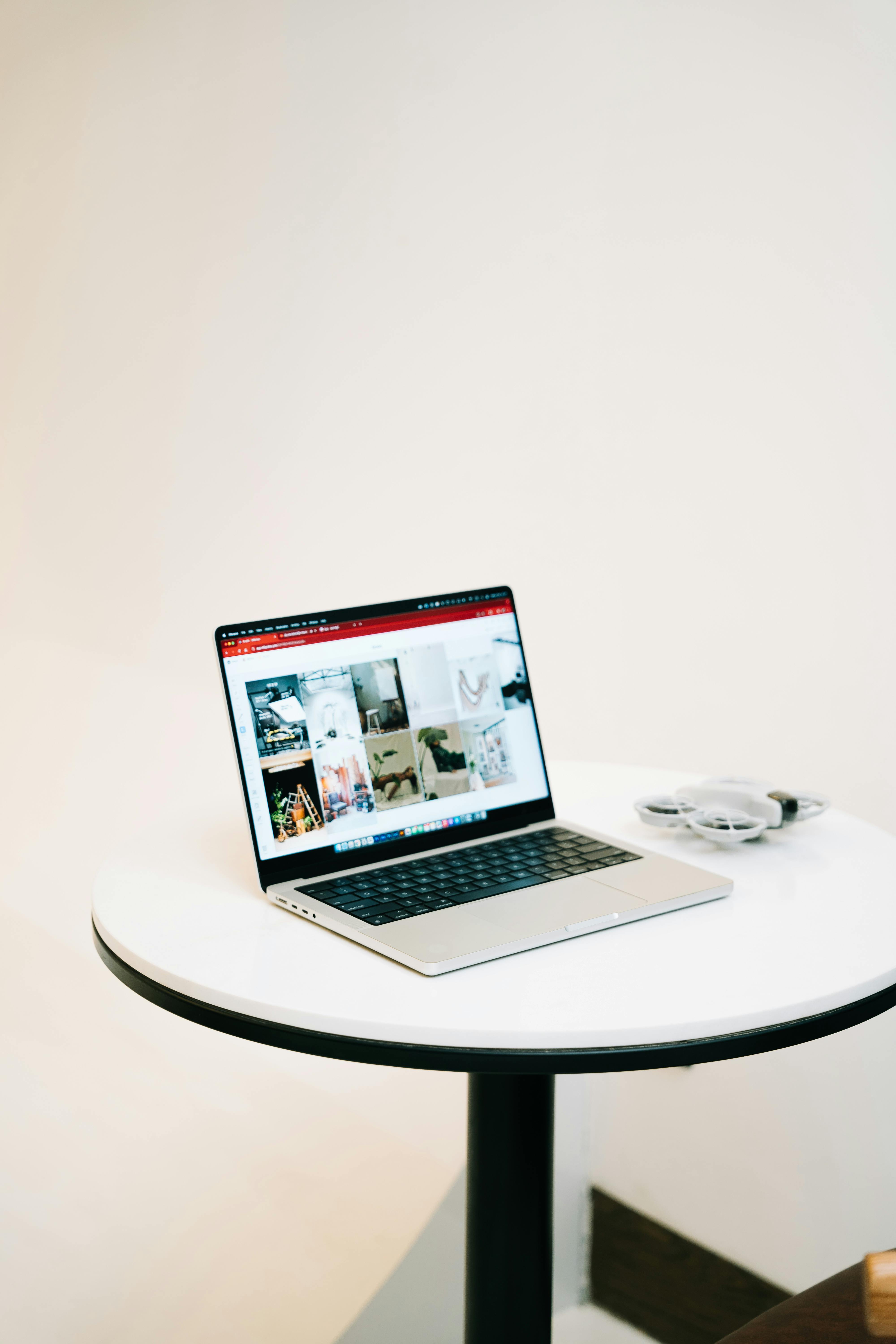 sleek laptop on minimalist round table