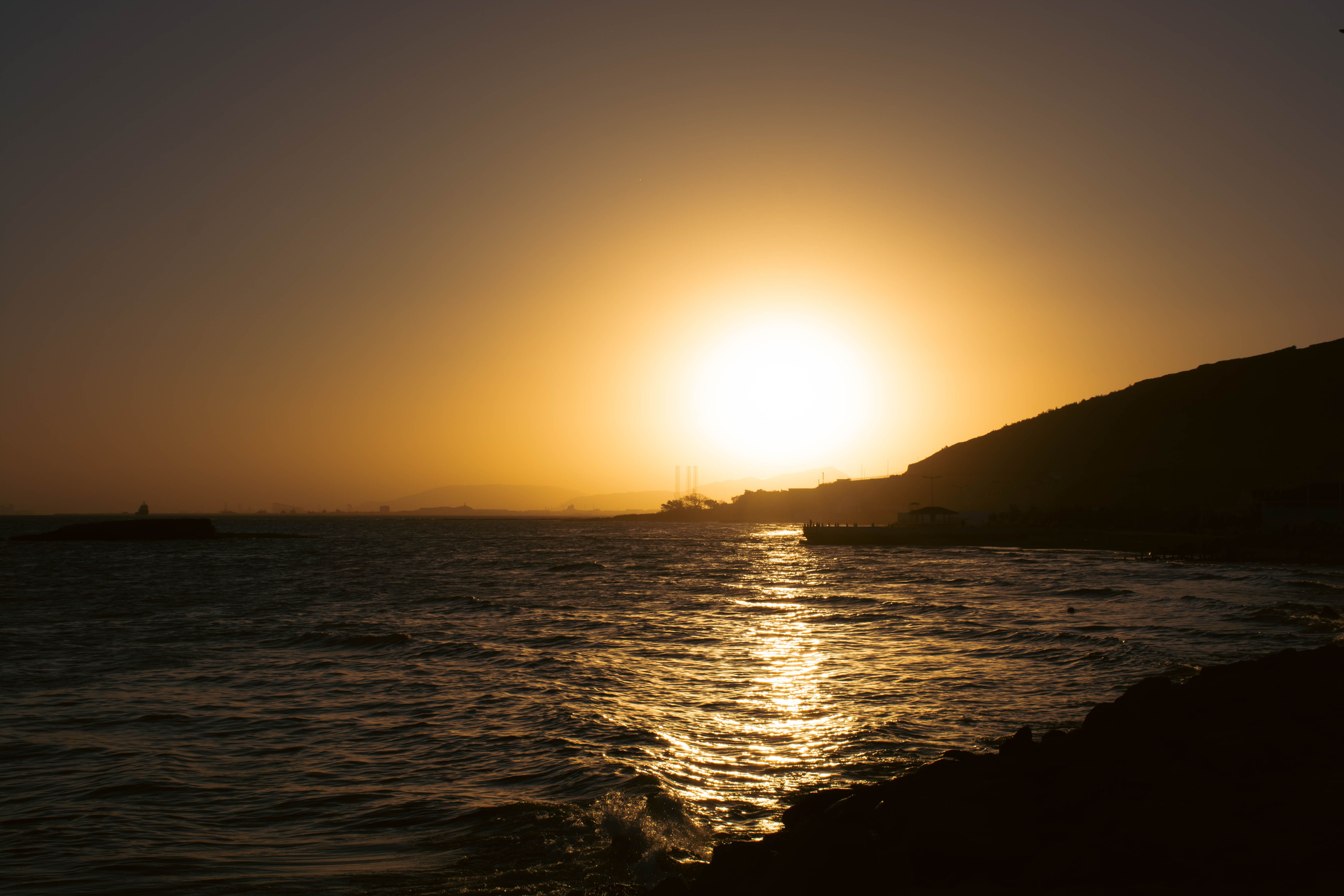 Serene Coastal Sunset With Golden Hour Glow · Free Stock Photo
