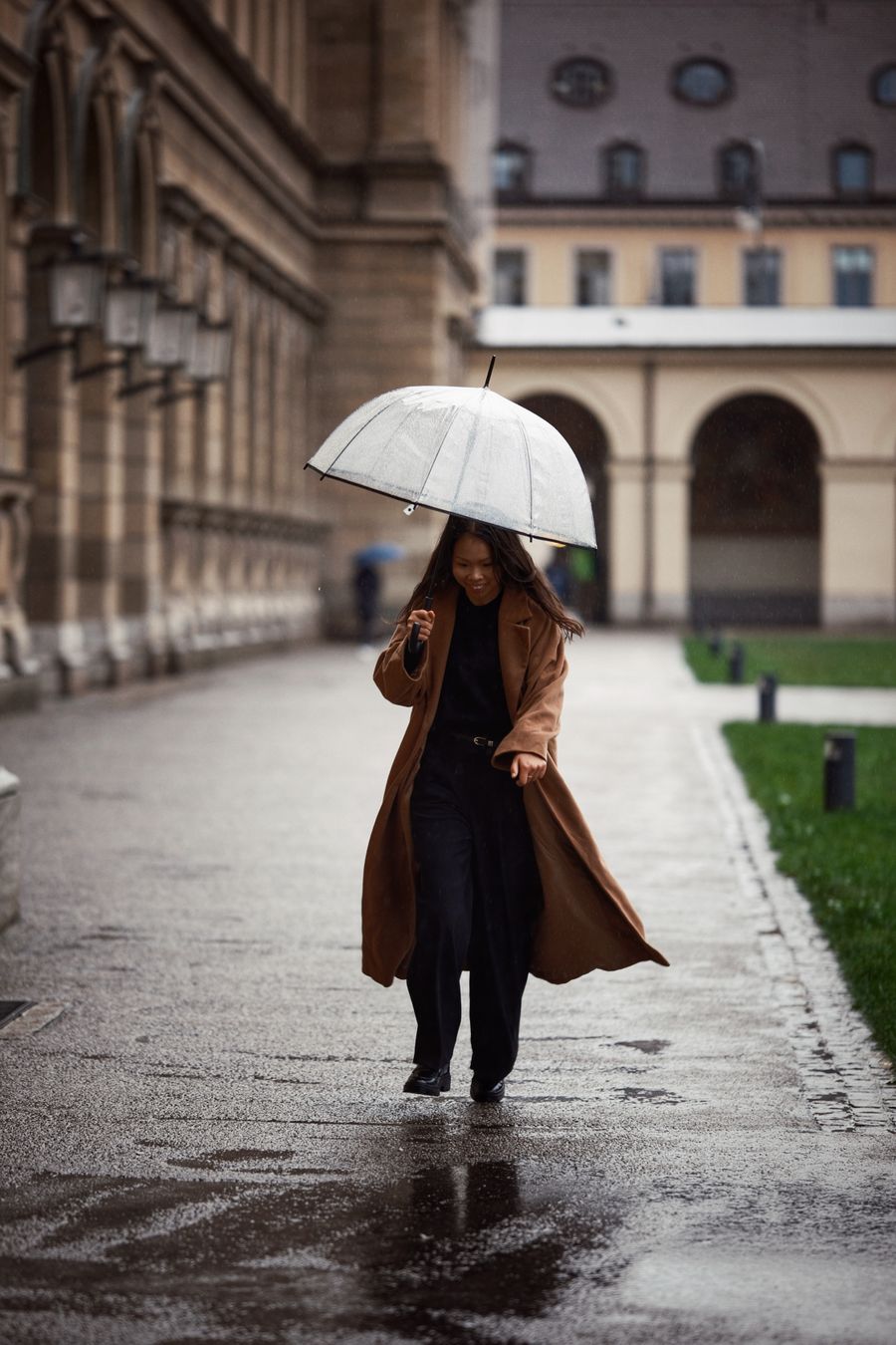Model in a teal anorak standing under falling rain — photo by Michael Obstoj on Pexels