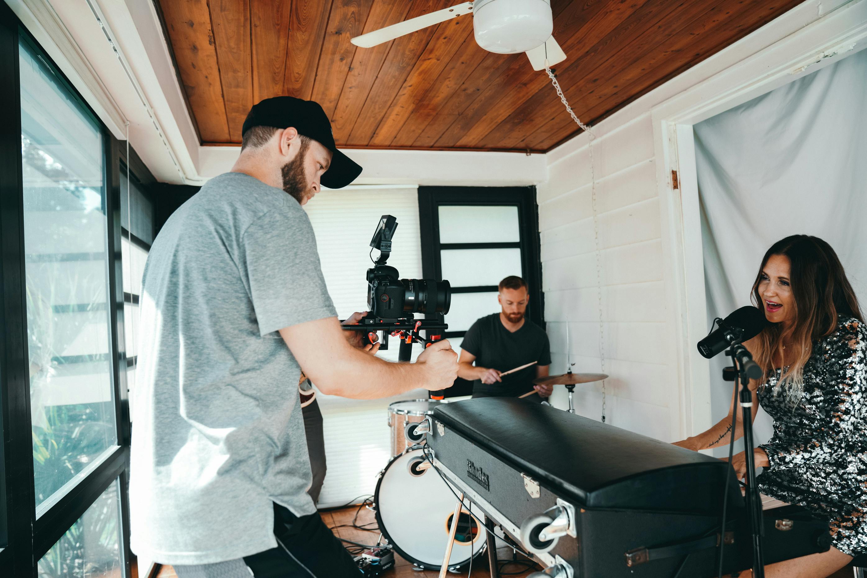 man filming a woman singing