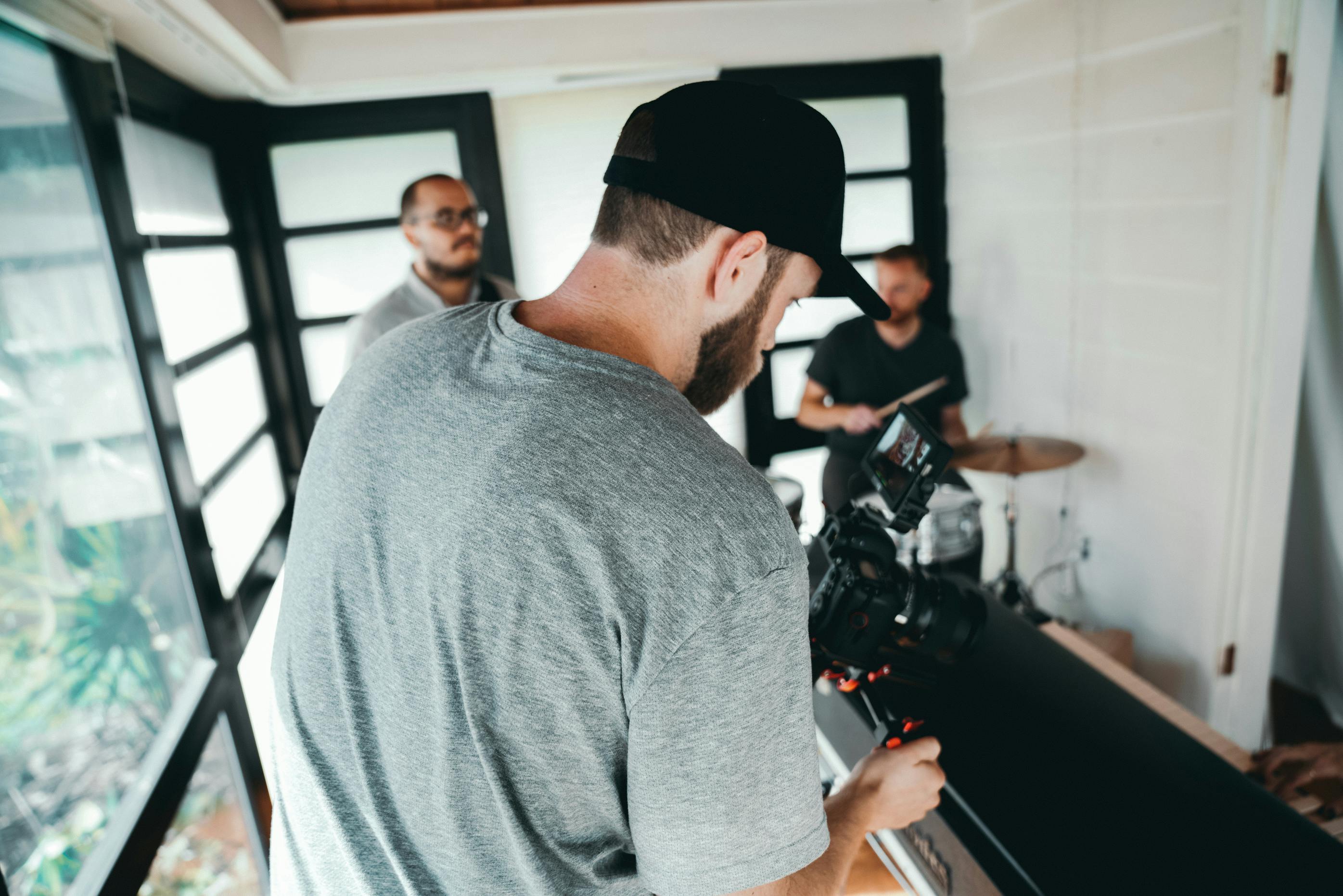 taking photo of a man playing instrument