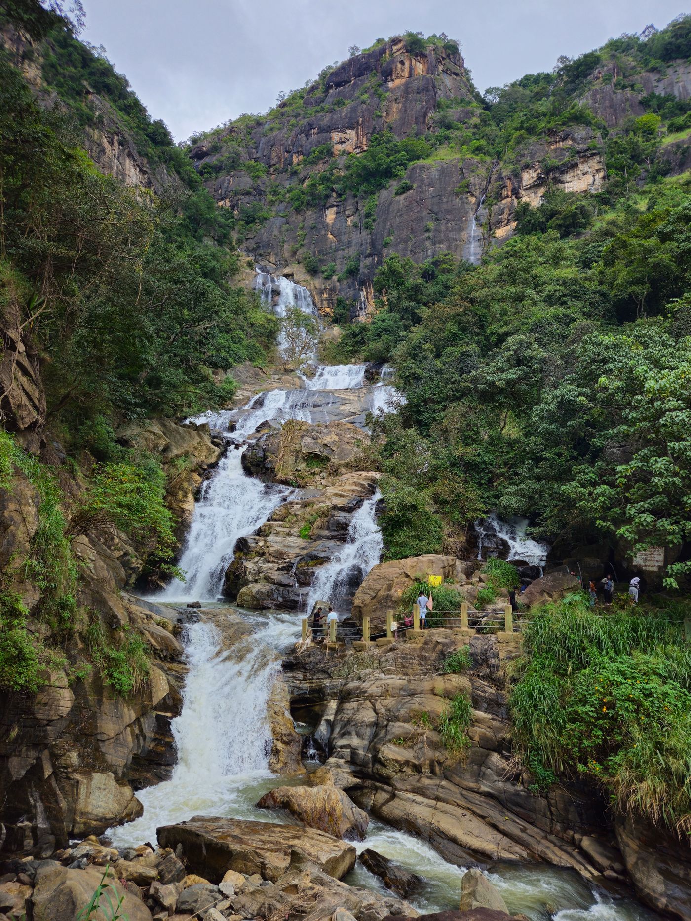 Ravana Falls surrounded by green mountains near Ella