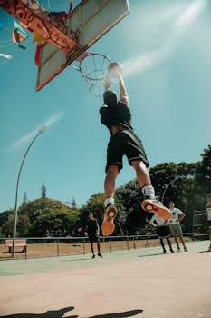 Basketball player mid-air attempting a dunk on a sunny day in Brasília.