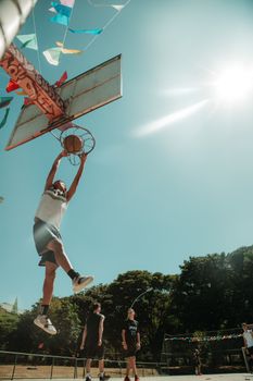 Dynamic basketball action featuring a player dunking under a sunny Brasília sky.