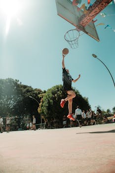 A vibrant outdoor basketball game with a player dunking under sunny skies in Brasília, Brazil.