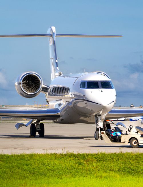 Free A sleek private jet being prepared for takeoff at the airport runway. Stock Photo