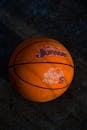 Close-up of Basketball on Court Surface in Shadow