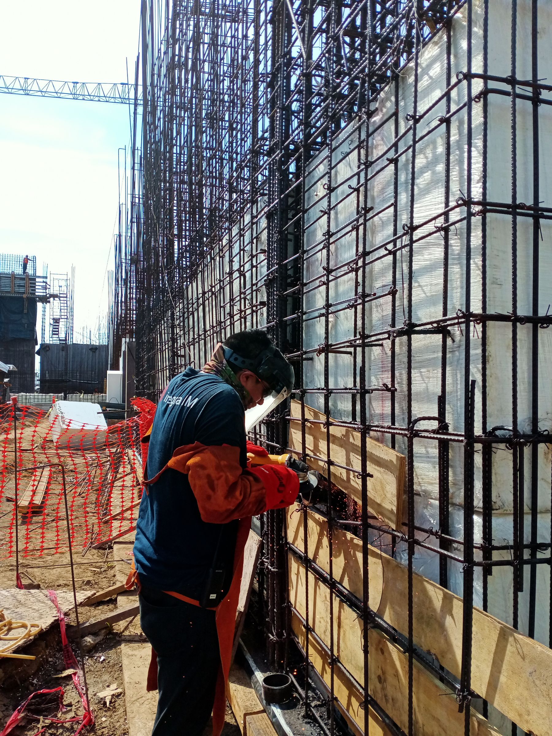 Worker welding a steel structure on a construction site