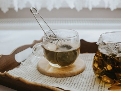 Cozy Tea Setup with Glass Teapot and Cup