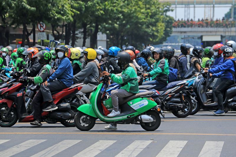 Motorbike riders queue up at an urban crossing