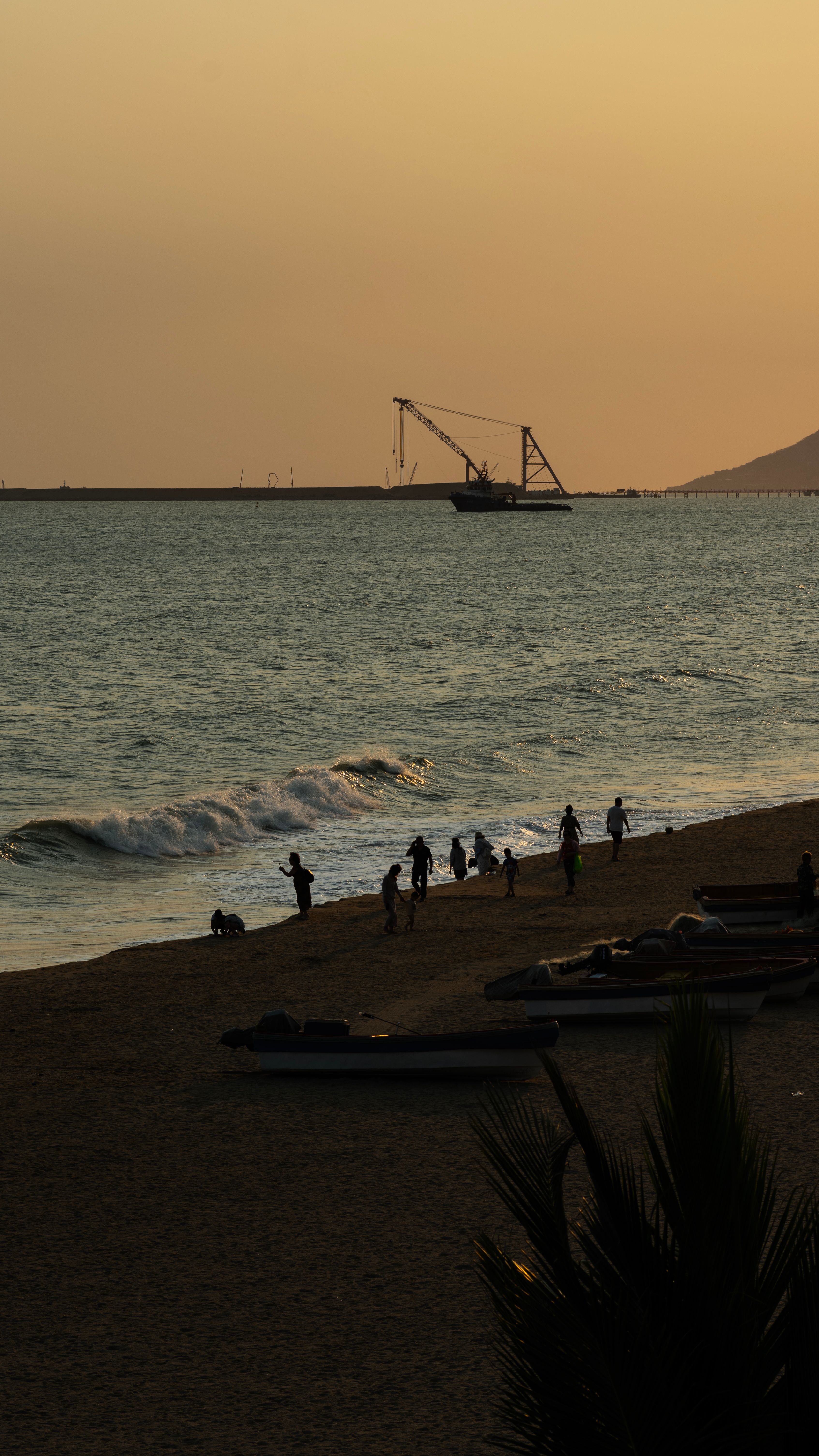 Sunset Beach Scene with Waves and People · Free Stock Photo