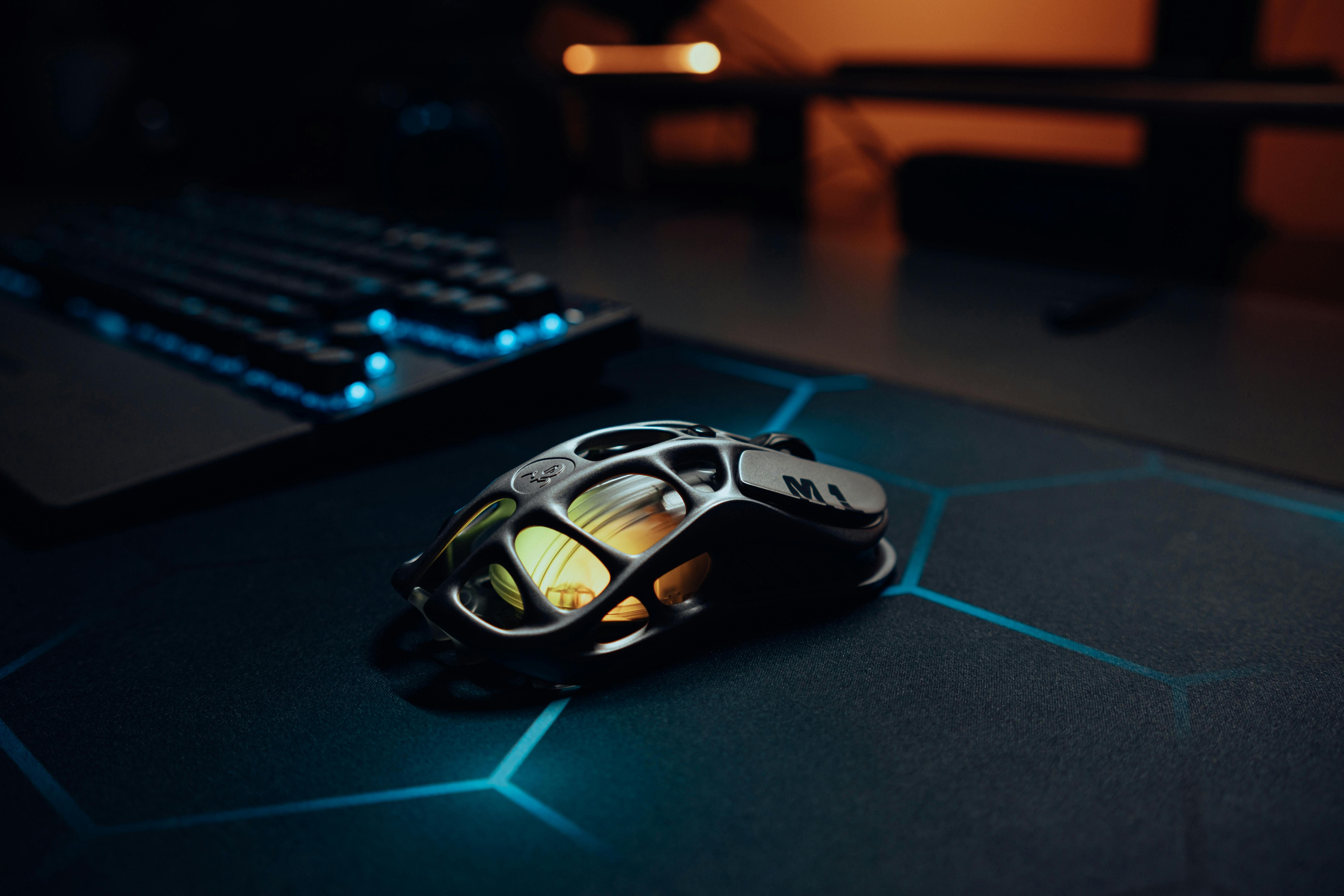 Futuristic gaming mouse with RGB lighting on desk