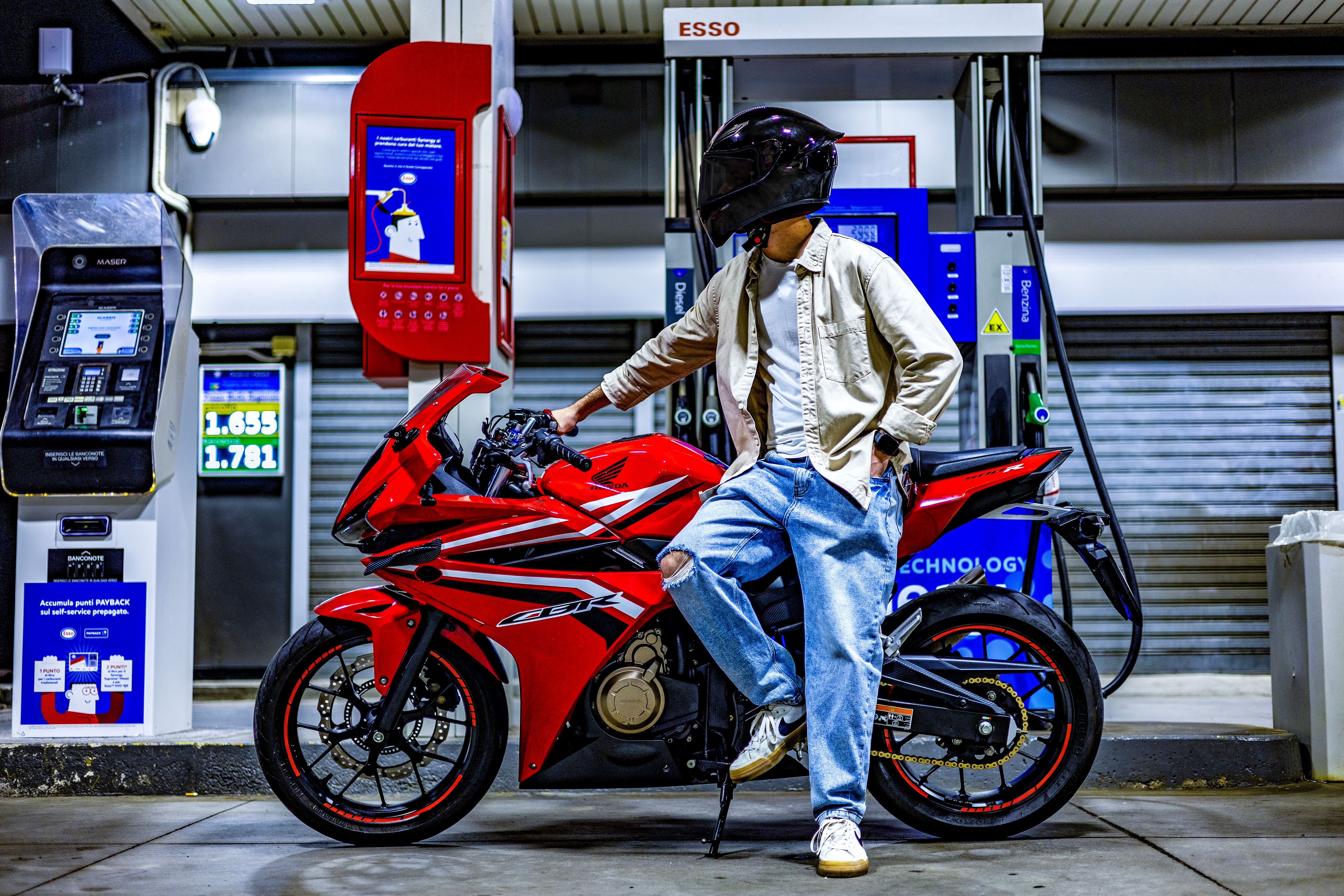 Motorcyclist at Gas Station with Red Sport Bike · Free Stock Photo