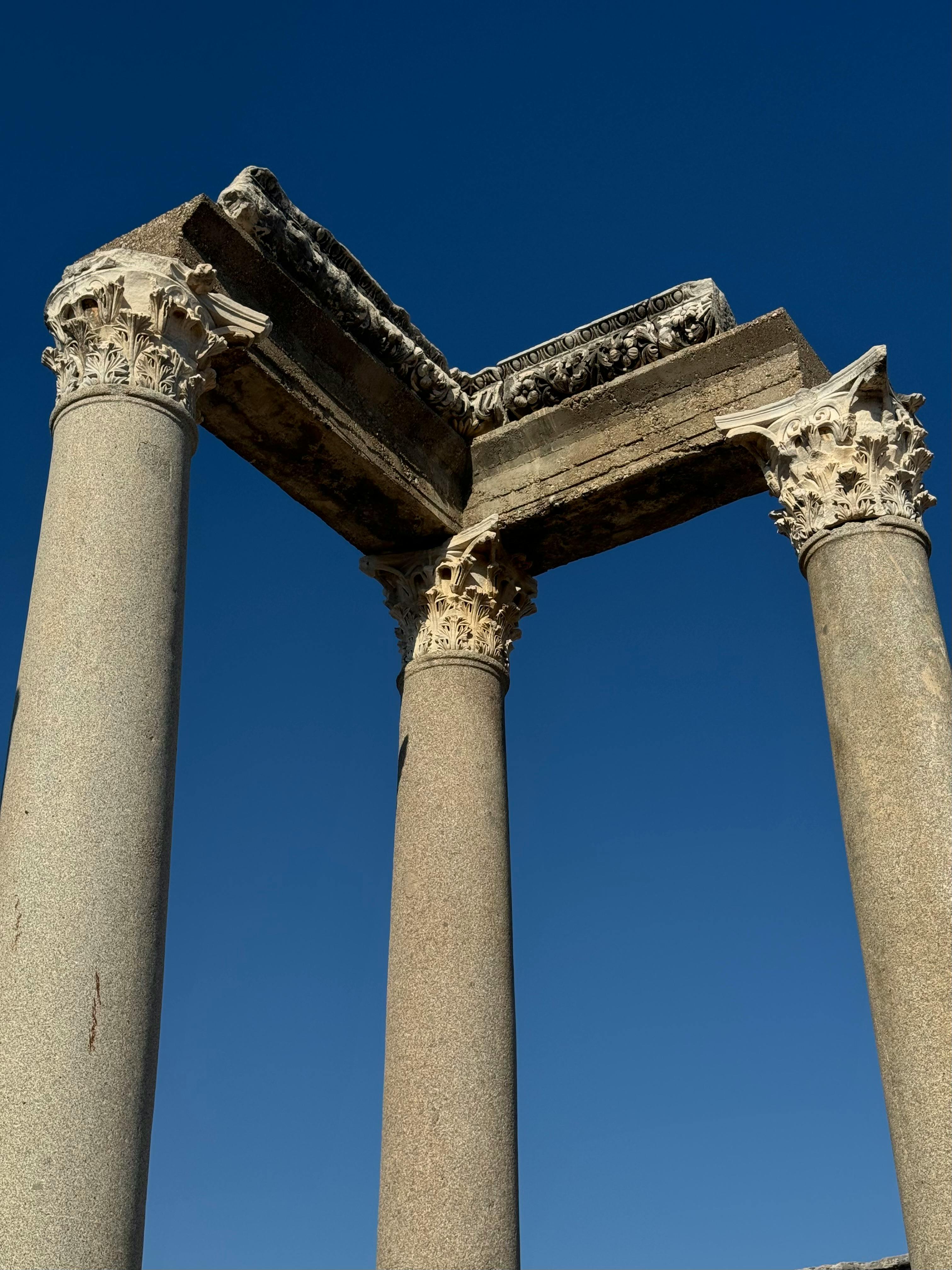 ancient roman columns against clear blue sky