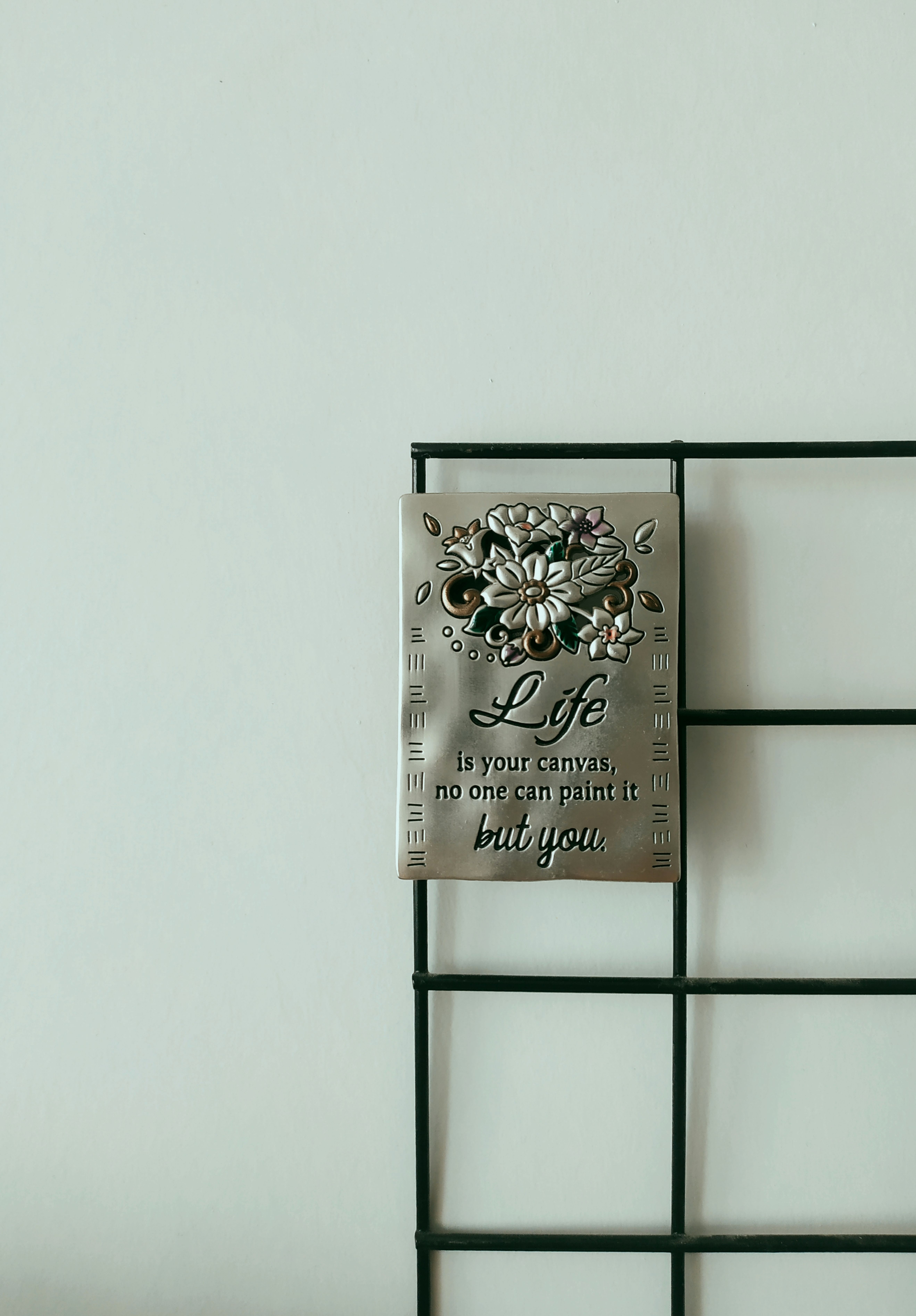 Inspirational Quote on Metal Plaque with Floral Design · Free Stock Photo