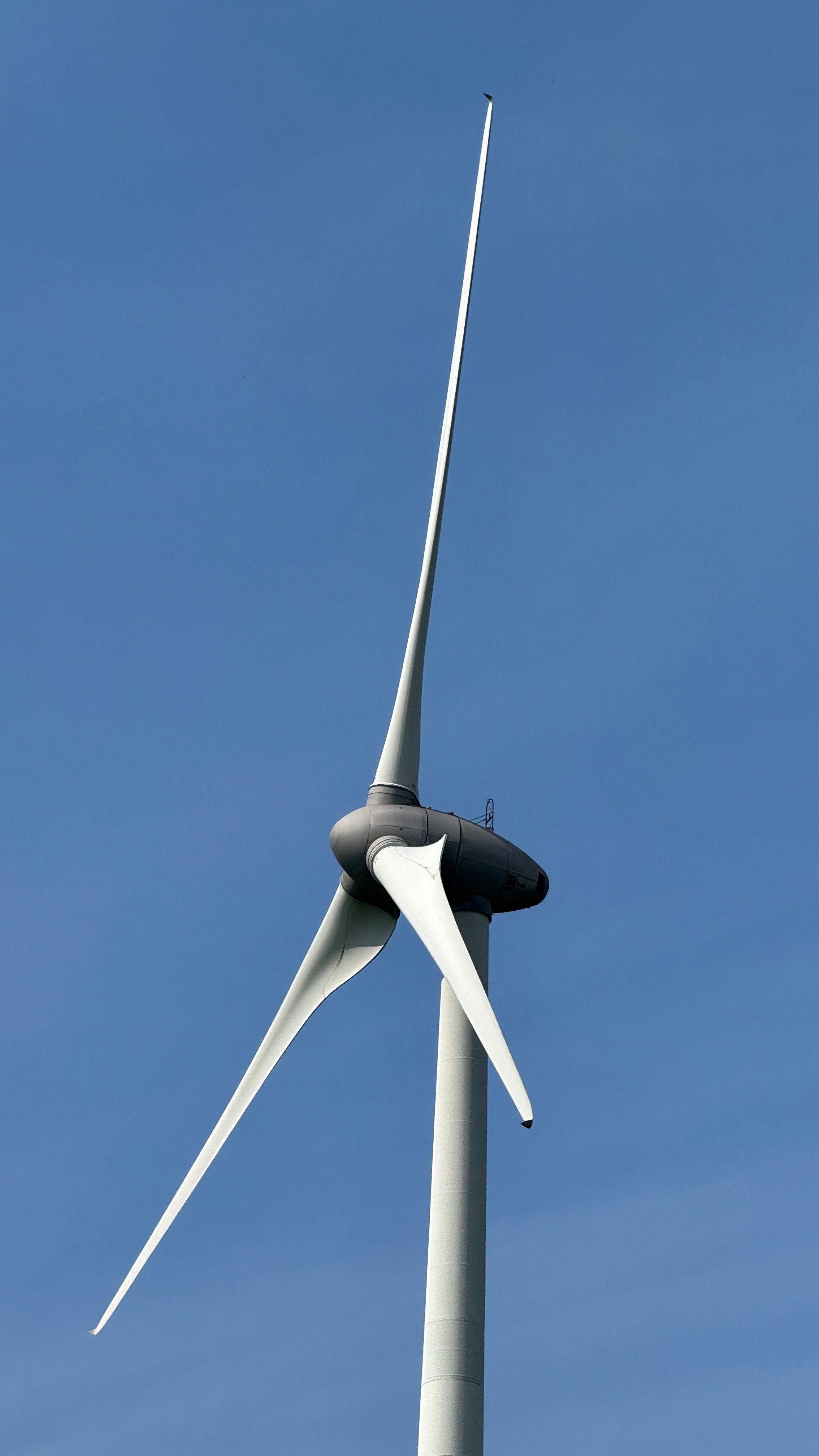 Scenic Wind Turbine Against Clear Blue Sky · Free Stock Photo