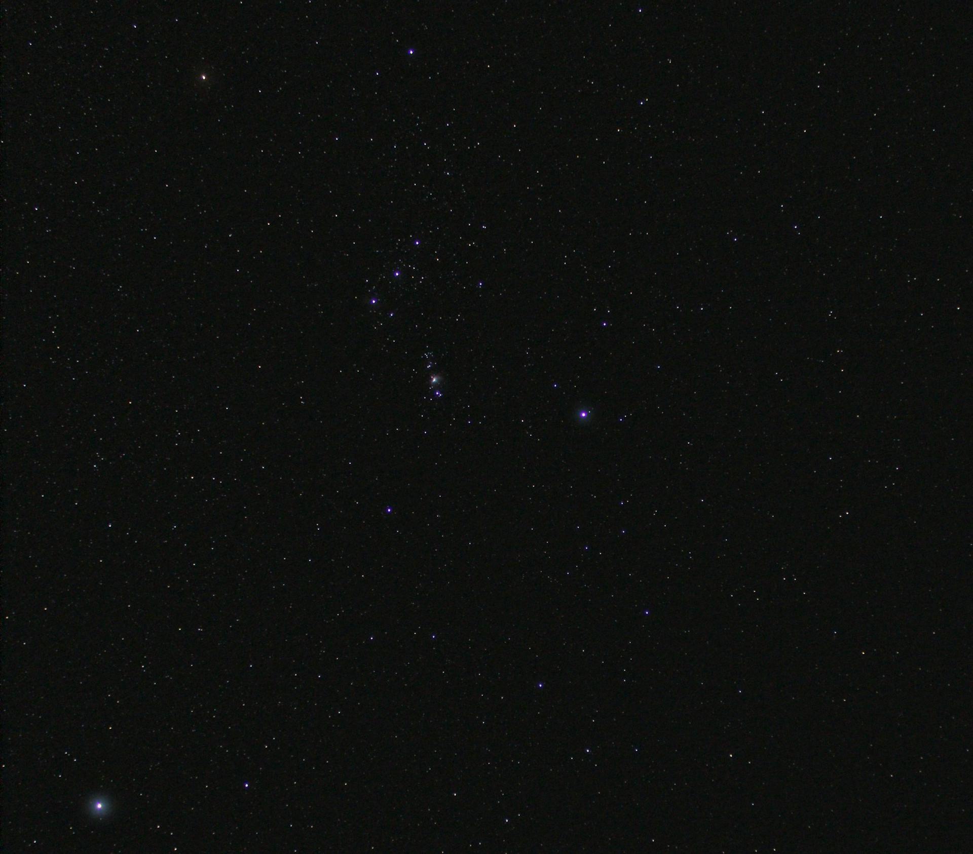 A clear view of the Orion constellation set against a starry night sky.