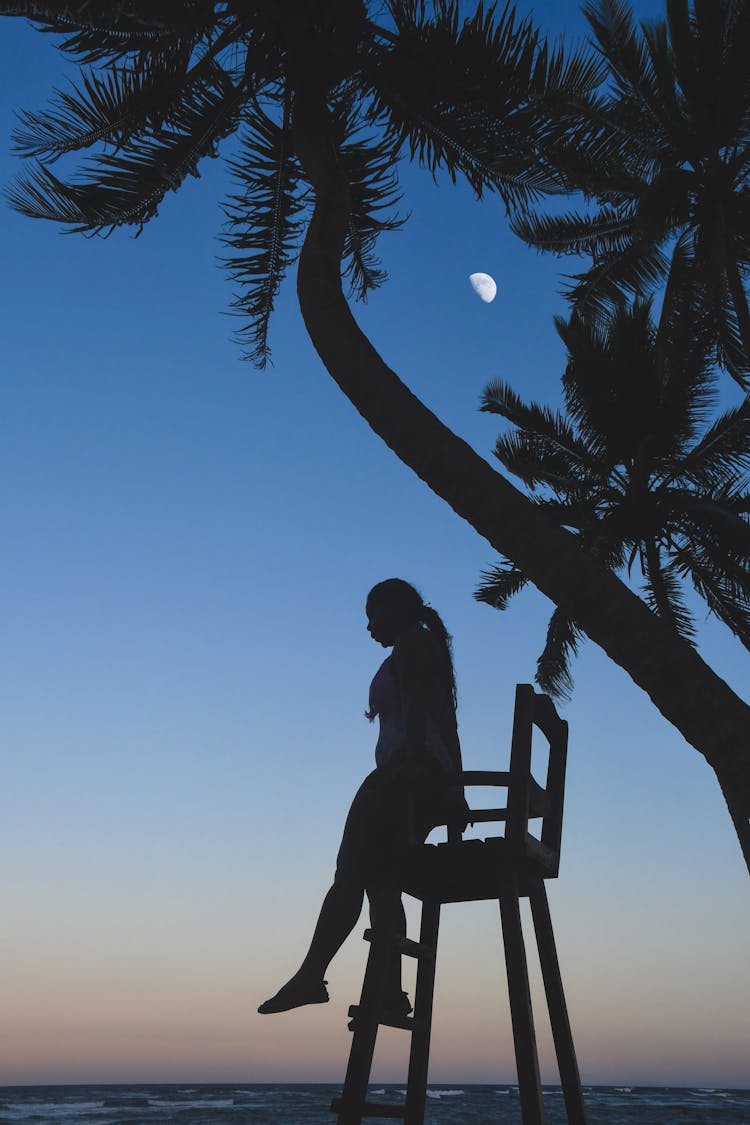 Silhouette Photo Of Woman Sitting On Beach Chair 