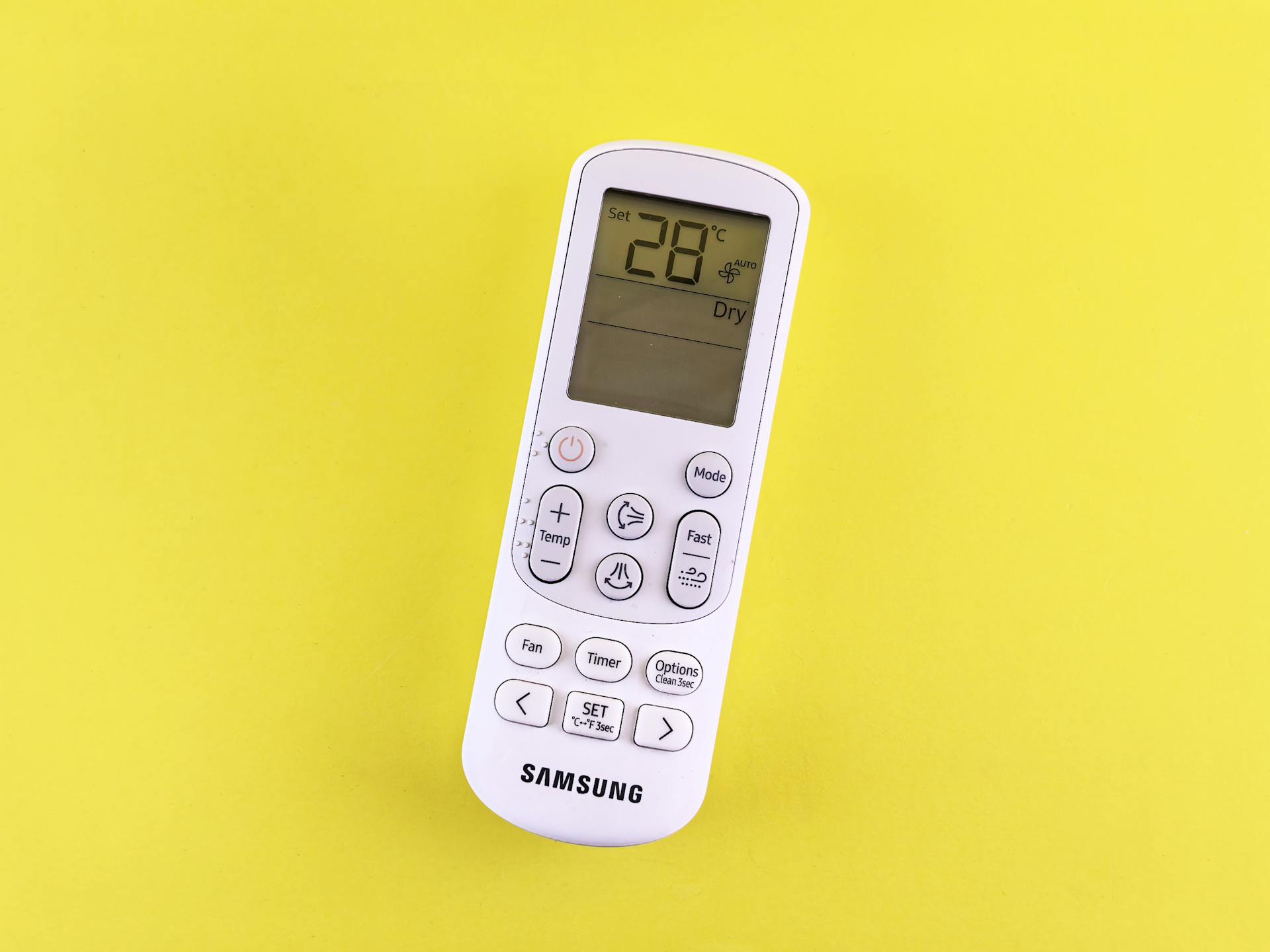 Air Conditioner Remote on Yellow Background