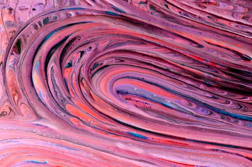 Free Vibrant abstract artwork featuring swirls of pink and purple paint creating a dynamic and fluid pattern. Stock Photo
