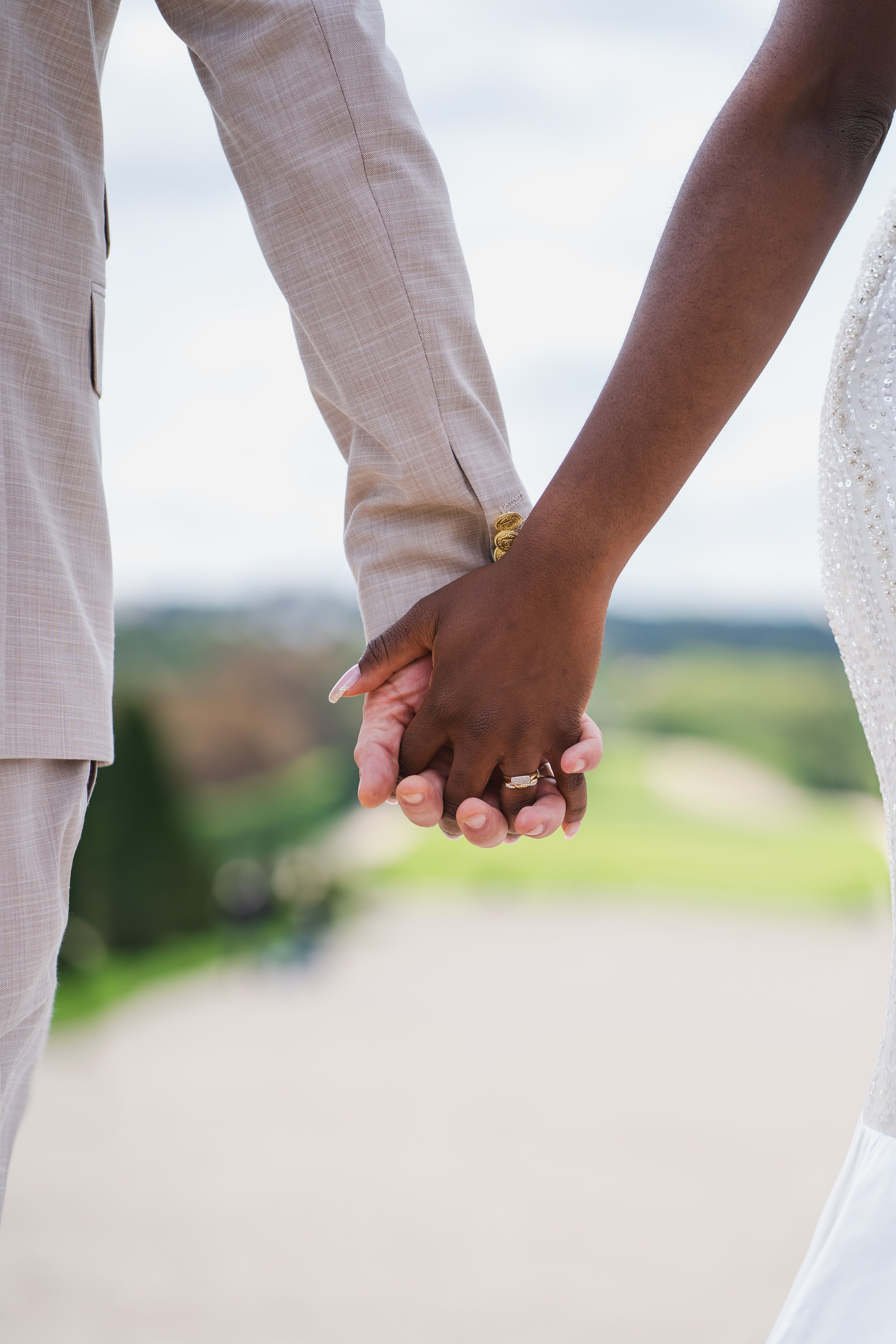 Romantic Wedding Couple Holding Hands Outdoors · Free Stock Photo