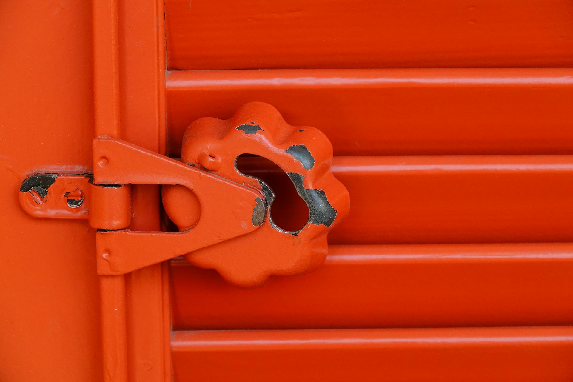 Worn Red Metal Lock Mechanism Close-Up